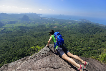 young woman backpacker enjoy the view on mountain peak