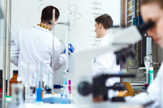 Young scientists carrying out an experiment in a laboratory.