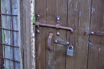 rusty iron bolt on a wooden door                     