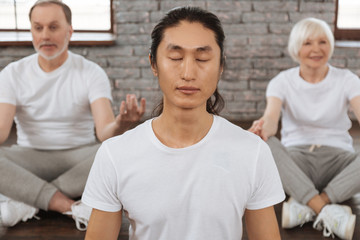 Fototapeta premium Portrait of calm male person holding his back straight
