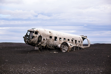 Airplane wreckage on black sand beach. Iceland