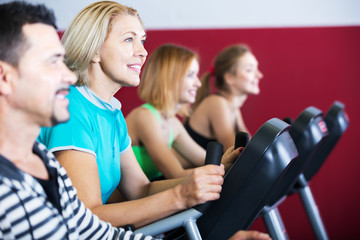 Fototapeta na wymiar Active adults in gym