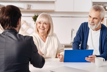 Successful lawyer working with aged couple in the house