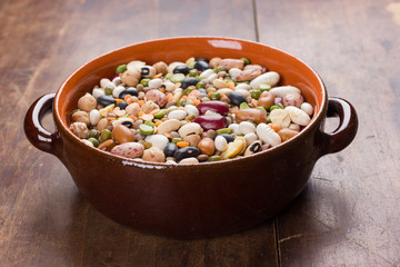 Mix of colorful beans and lentils in rustic bowl