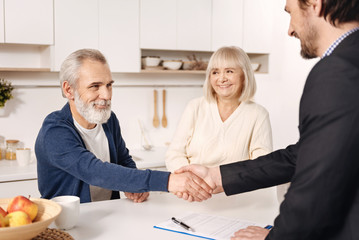 Successful broker meeting with elderly couple of clients