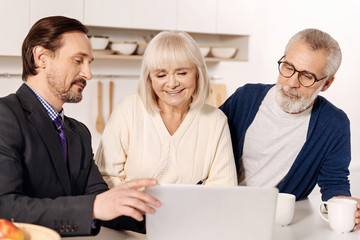 Peaceful agent presenting plan of the house to future owners