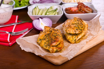 Fried chicken meat on wooden board, and other food