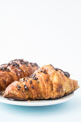 Fresh croissant on the white plate. Place for text, copy space.