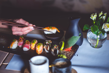 Man eating sushi set with chopsticks on restaurant - 140462044