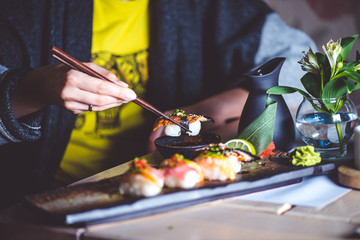 Man eating sushi set with chopsticks on restaurant - 140462056