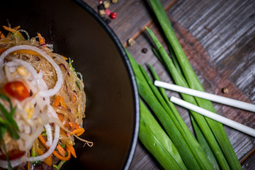 Noodles in bowl on wood table top
