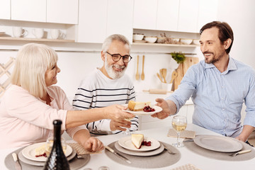 Smiling man enjoying family dinner at home