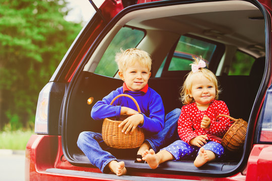 happy little boy and girl travel by car
