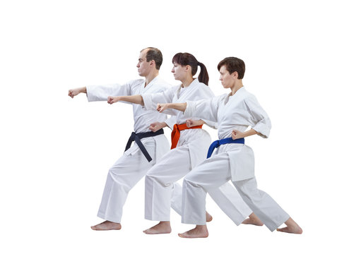 On a white background three adult athletes are beating punch arm isolated
