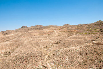 Fototapeta na wymiar Destroyed long stone walls in the desert