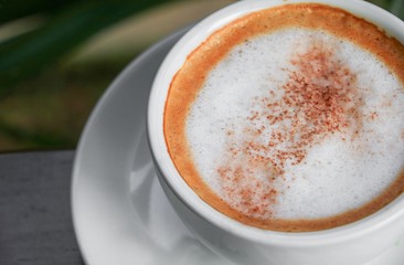 close up coffee cappuccino on the wooden floor background