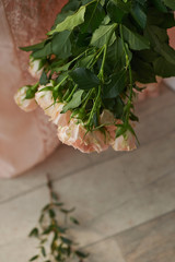 Bouquet of delicate pink spray roses on a background of pink lace dress