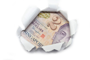 Singapore currency peeking through white paper