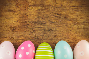 Colorful easter eggs in front of an old wooden background