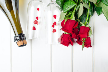 Valentines day cards. Bouquet of red roses on white wooden board. Top view.