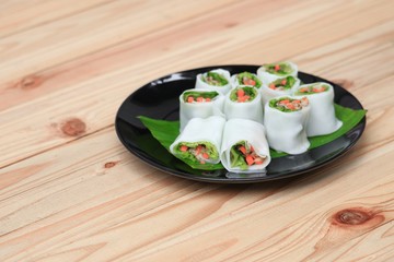 spring roll and vegetable  on banana leaf in plate, Select focus with shallow depth of field.