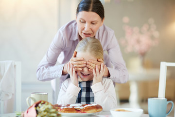 Senior woman making surprise for her granddaughter