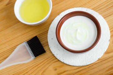 Homemade mask made of sour cream (greek yogurt) and olive oil. Diy cosmetics