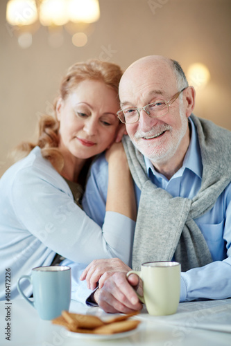 Portrait Of Smiling Mature Couple Sitting Close Together