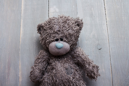 toy teddy bear on wooden background
