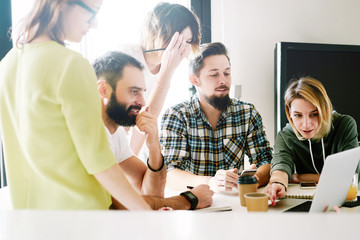 Digital designers are discussing new concept during the meeting with the colleagues. Business...