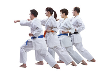 Fototapeta na wymiar In karategi the sportsmen are hitting a punch on a white background