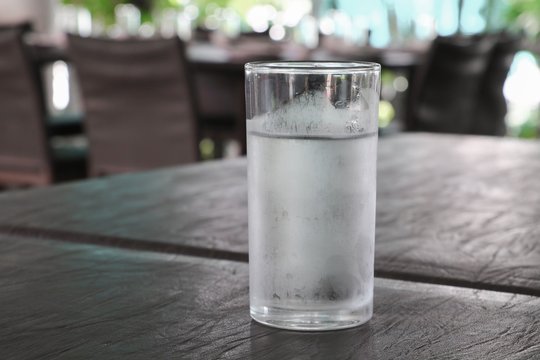 Glass of cold water on table