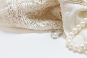 Female accessories frame with white lace dress, jewellery and copy space