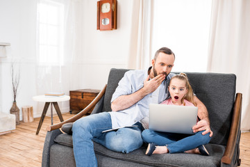 Obraz premium Father and daughter using laptop