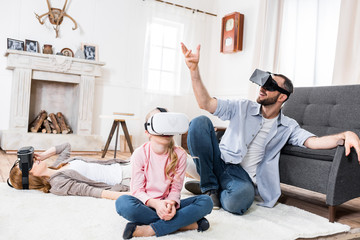 Family in virtual reality headsets