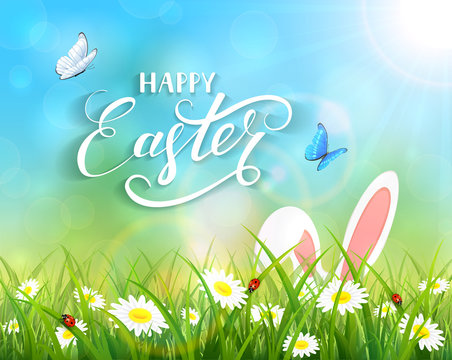 Blue background with Easter bunny in grass