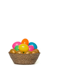 easter eggs in a basket on white background
