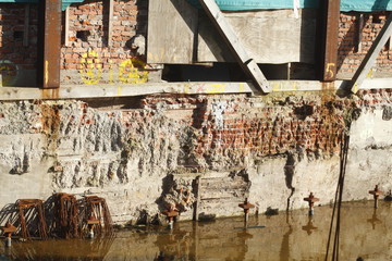Wand, mit Wasser vollgelaufene Baugrube