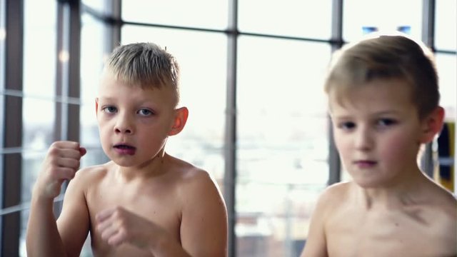 Two little boys practicing boxing