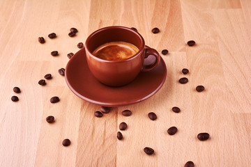 Espresso cup on wooden background.