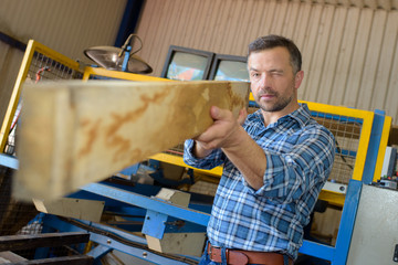 sawmill employee working with wood tools and machinery