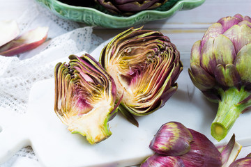 Fresh big Romanesco artichokes green-purple flower heads ready to cook