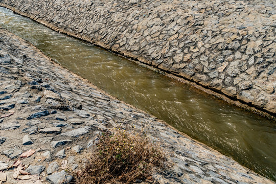 Irrigation canal with stone wall