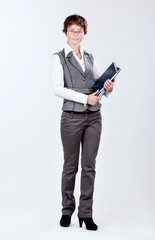 Full body portrait of a beautiful caucasian businesswoman or teacher with glasses and books
