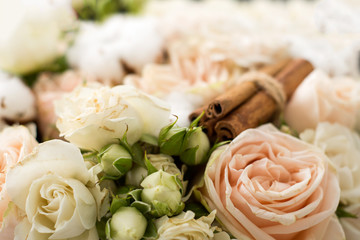 Bouquet made of white cotton, roses and cinnamon. Pastel colors