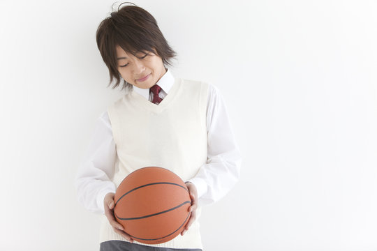 School Boy in Uniform Holding Basket Ball