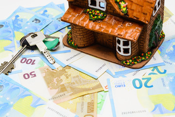 Keys and house on the background of the euro cash