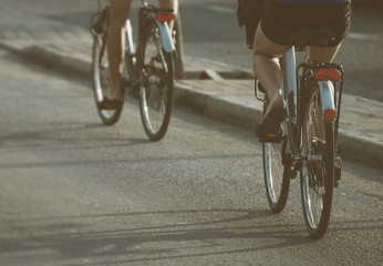 Women riding on bicycles around the city.