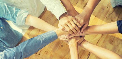 Teamwork concept,Business team standing hands together in the loft office.people joining hands for...