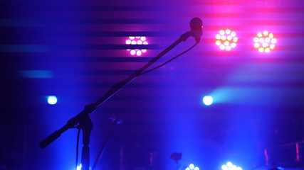 Stage lighting, equipment, beam and microphone stand in a night club